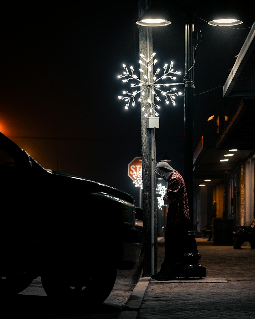 a woman standing next to a pole with a snowflake on it