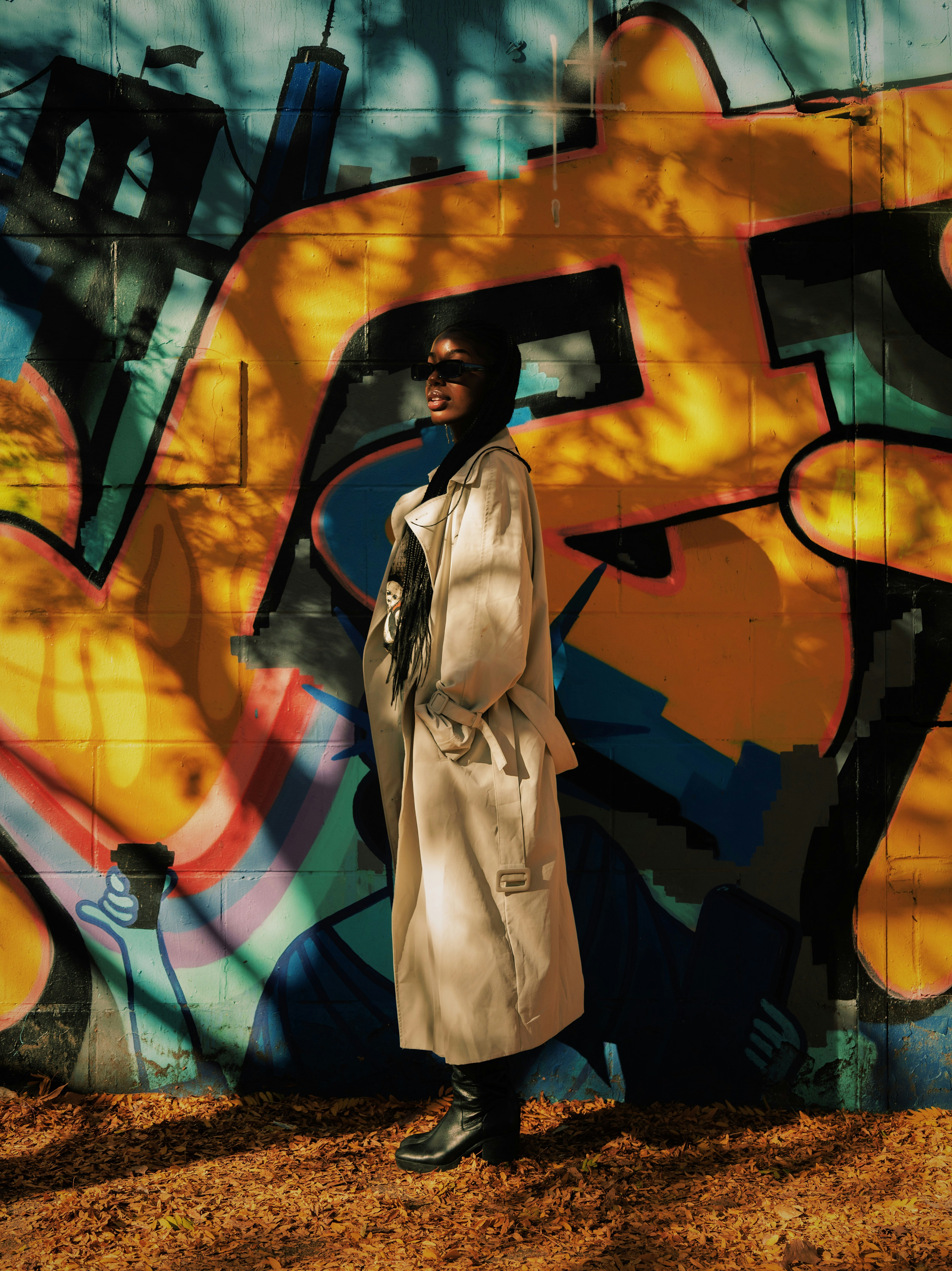 a woman standing in front of a graffiti wall