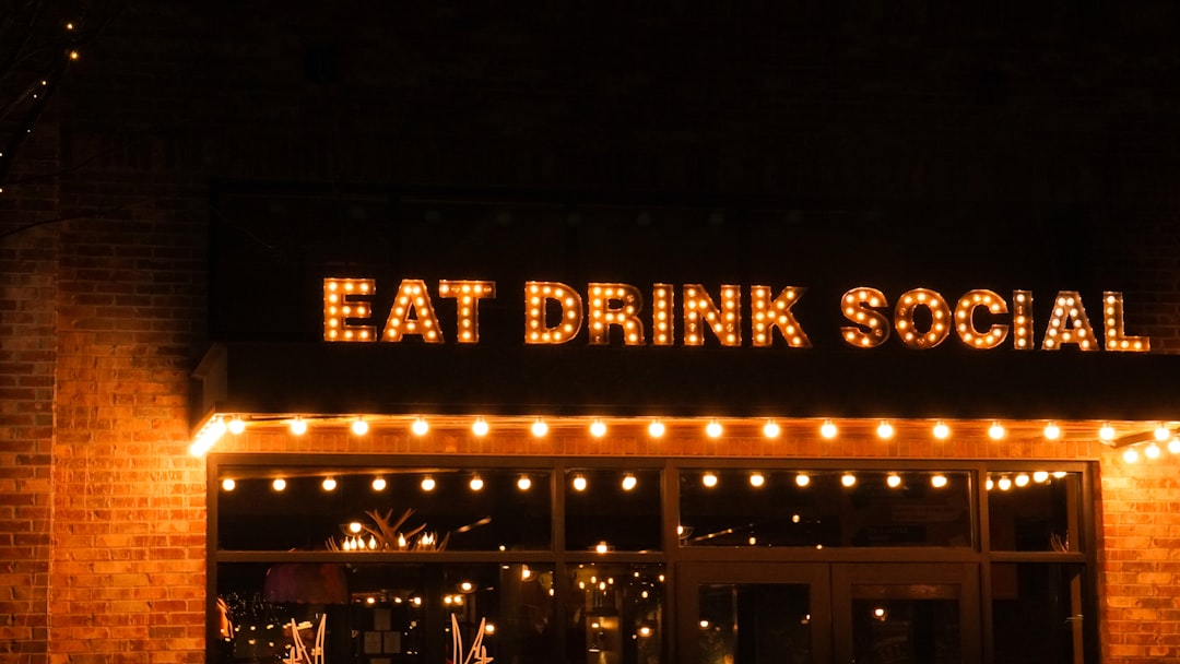 a brick building with a sign that says eat drink social,
