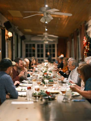 Family and friends enjoying a meal together during a visit