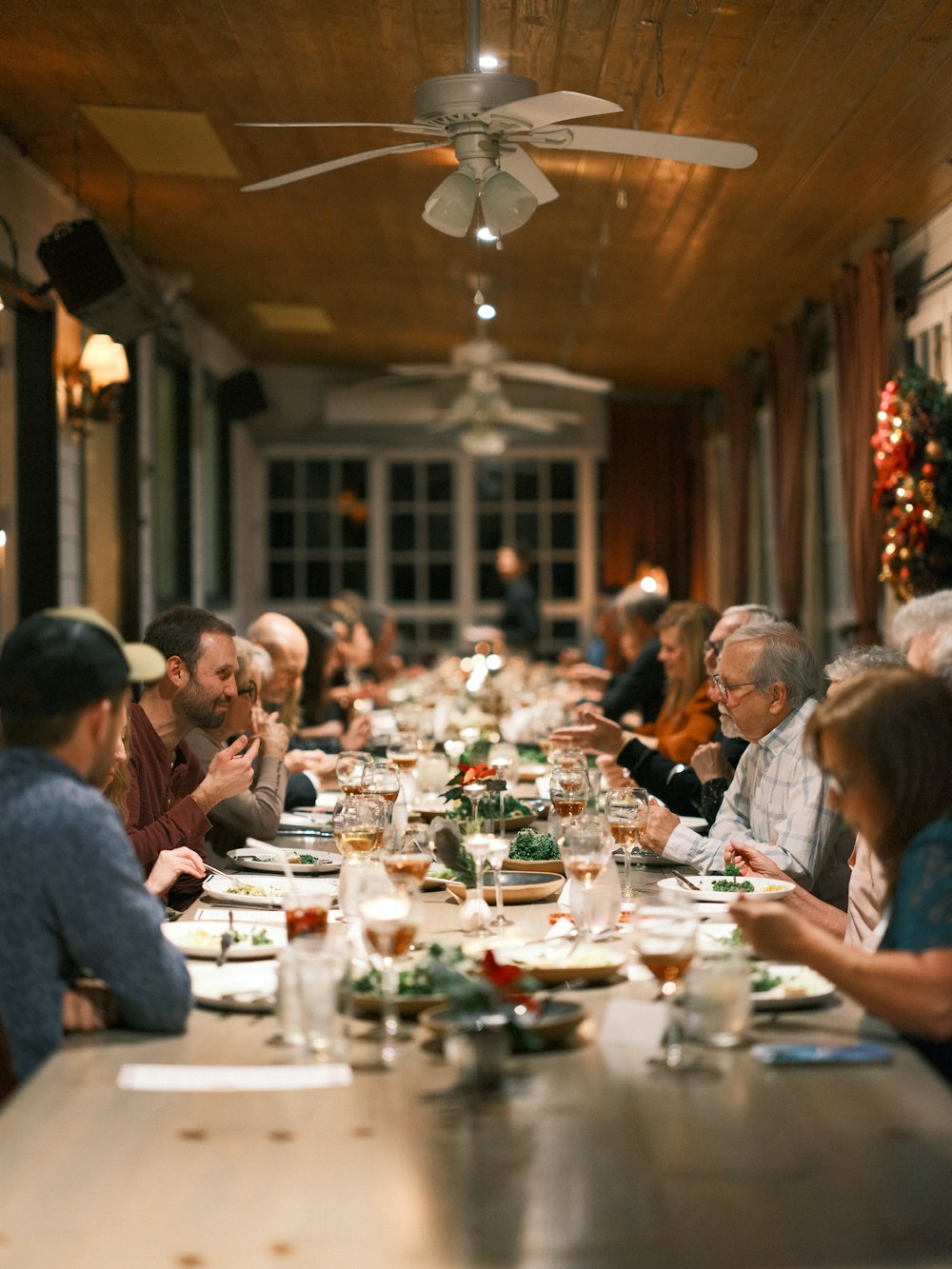 a group of people sitting at a long table