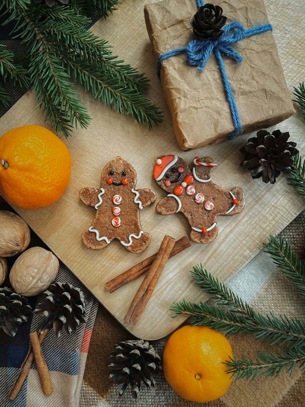 a wooden cutting board topped with cookies and oranges