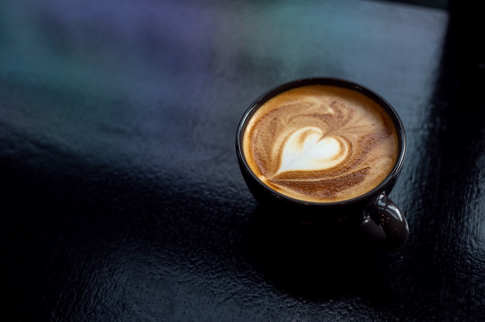 a cappuccino with a heart in it on a table