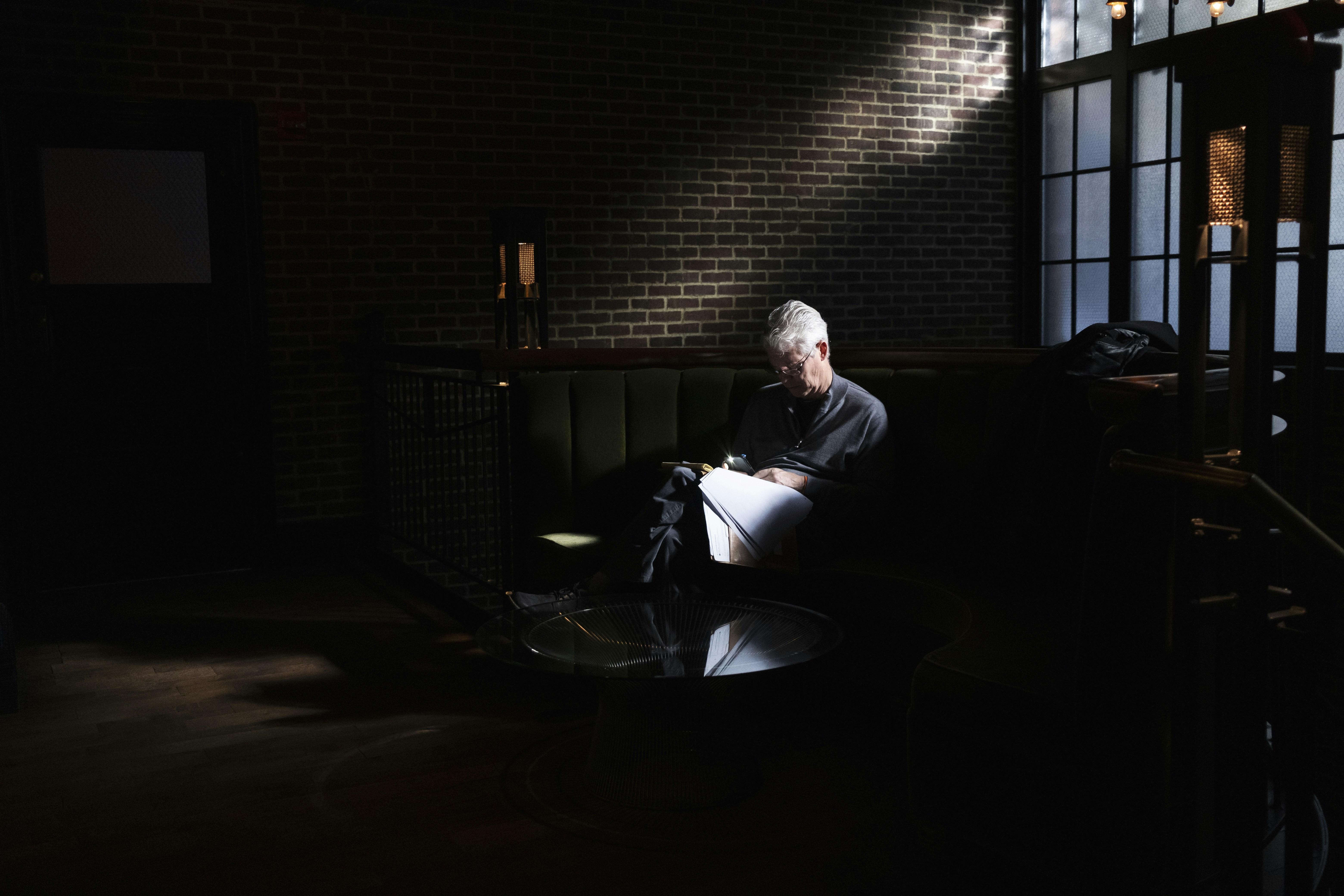 a man sitting on a couch in a dark room