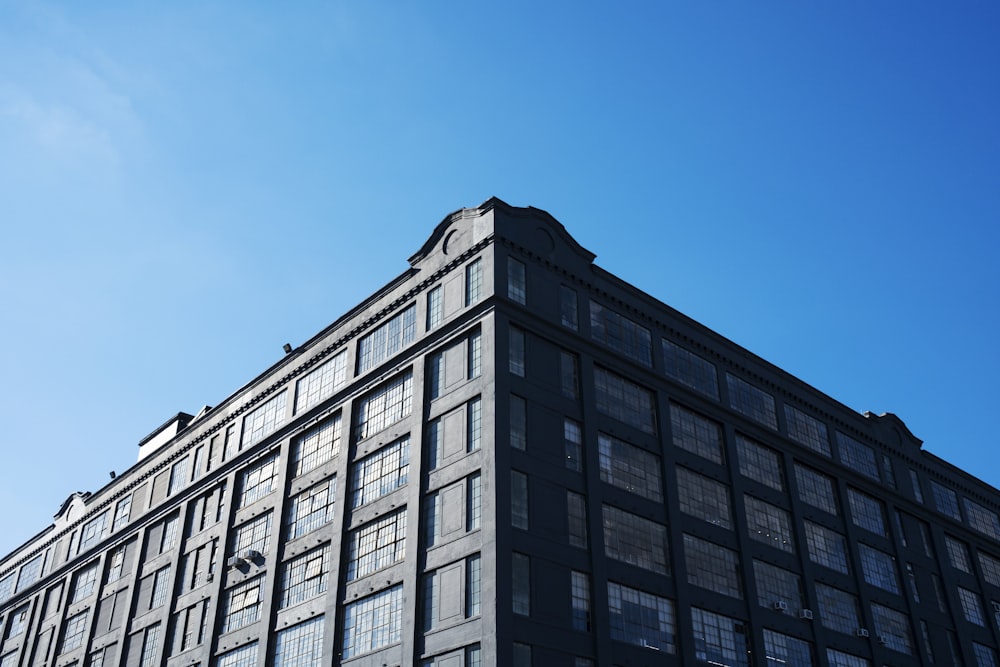 a tall building with lots of windows against a blue sky