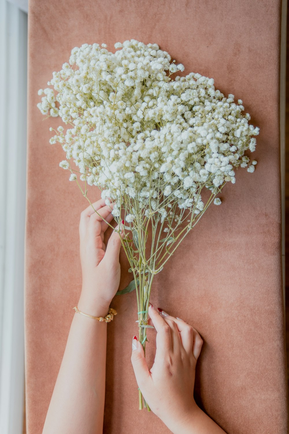 a woman is arranging a bouquet of flowers