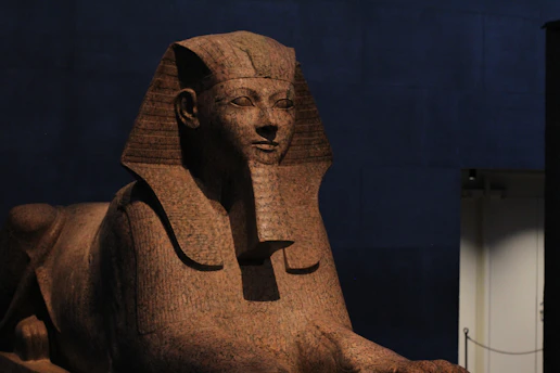 A regal sphinx statue bathed in soft golden light, evoking ancient Egyptian grandeur.