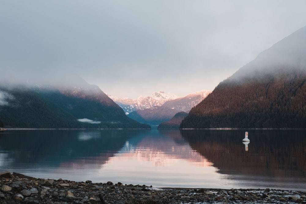 a body of water with mountains in the background