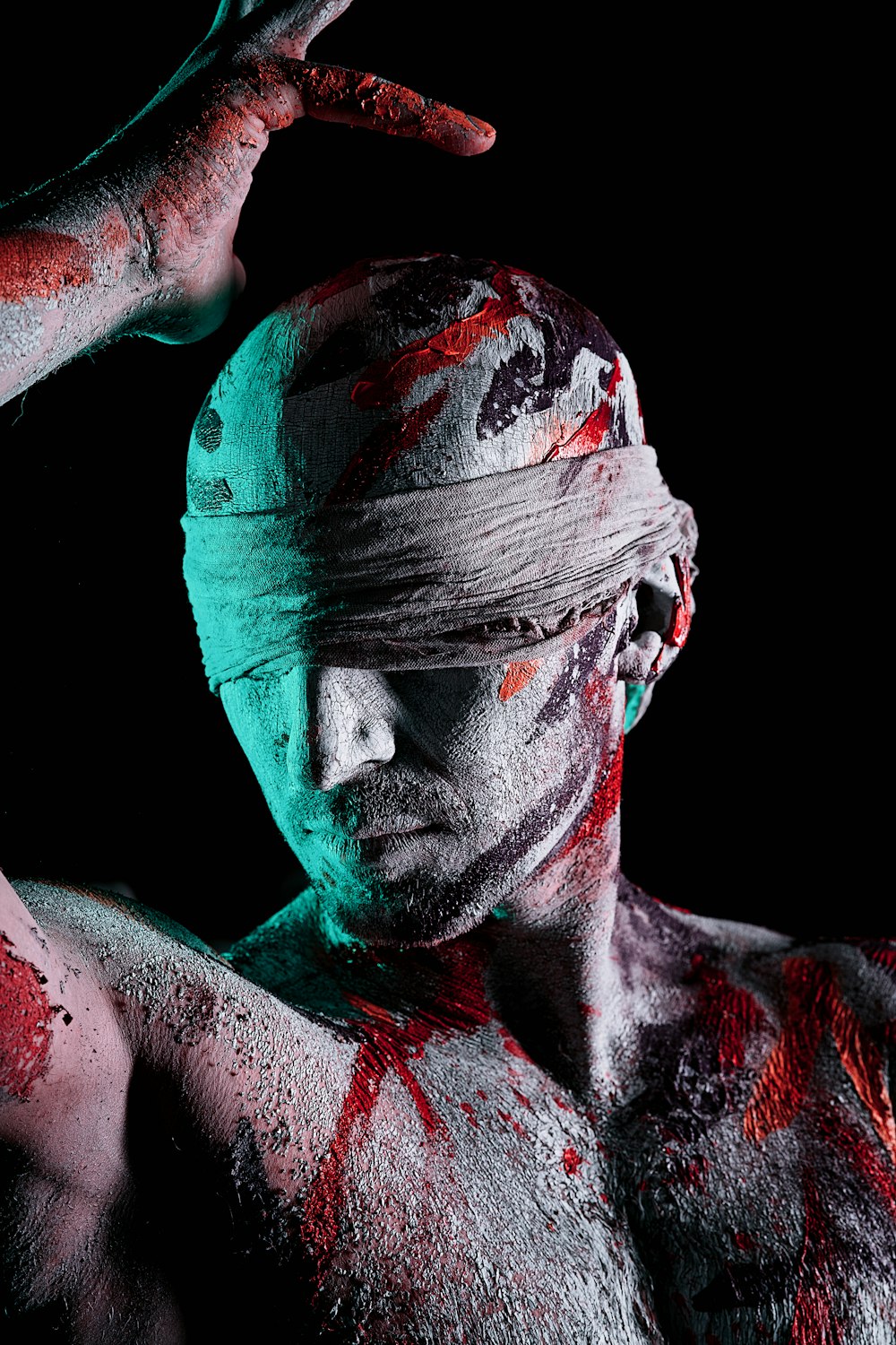 a man is covered in white and red paint