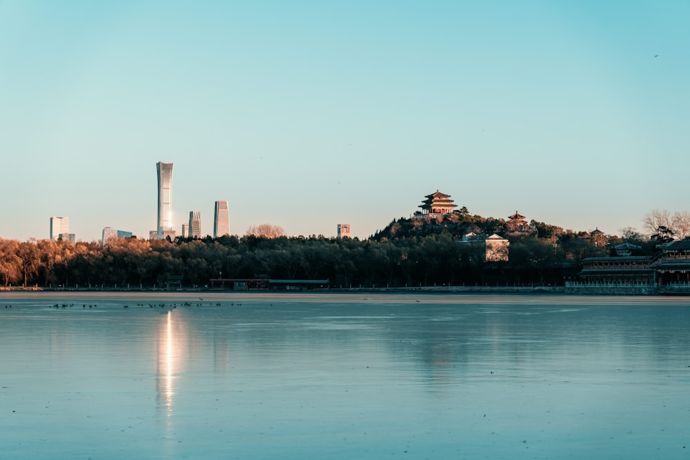 a large body of water with a city in the background