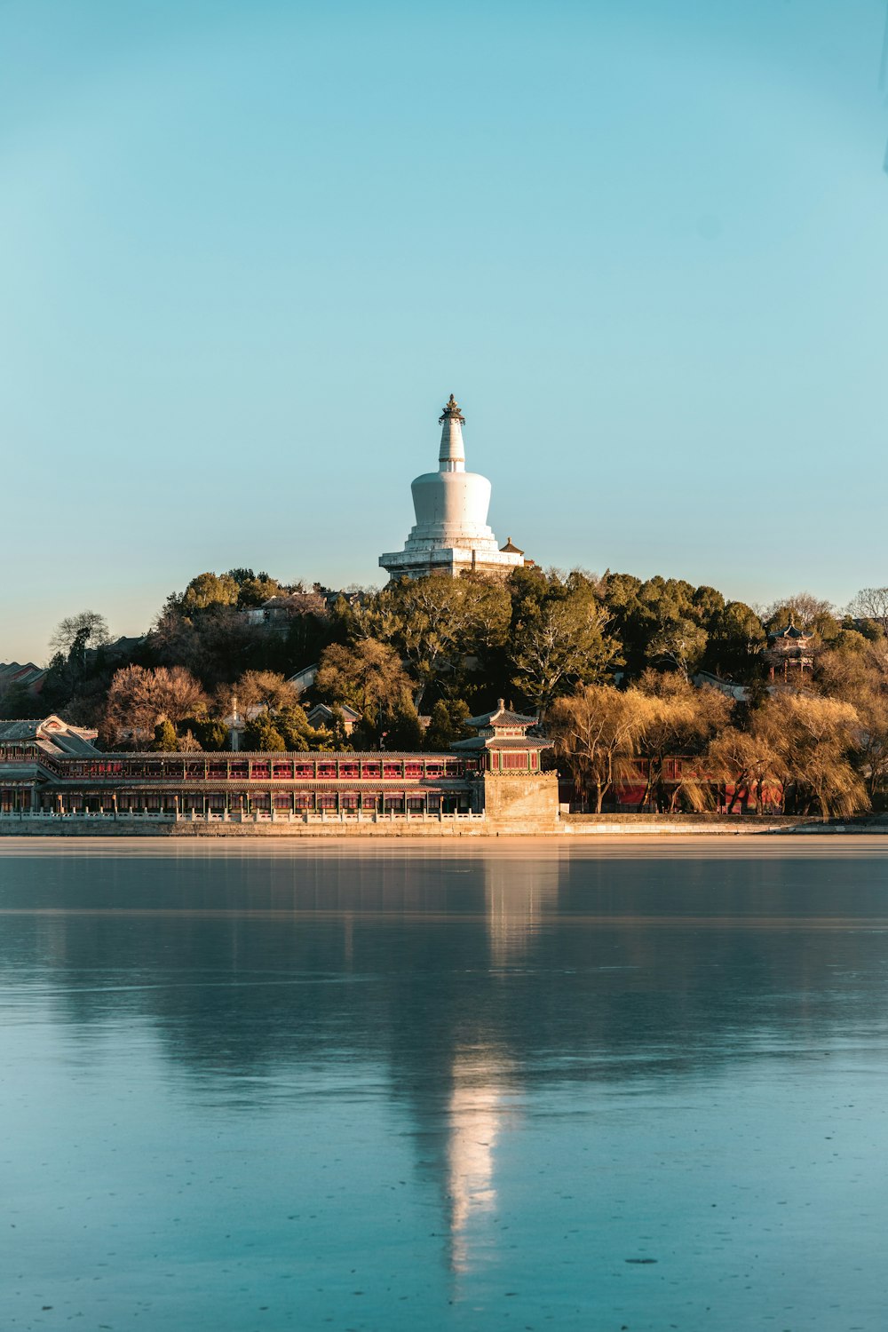 a large body of water with a building in the background