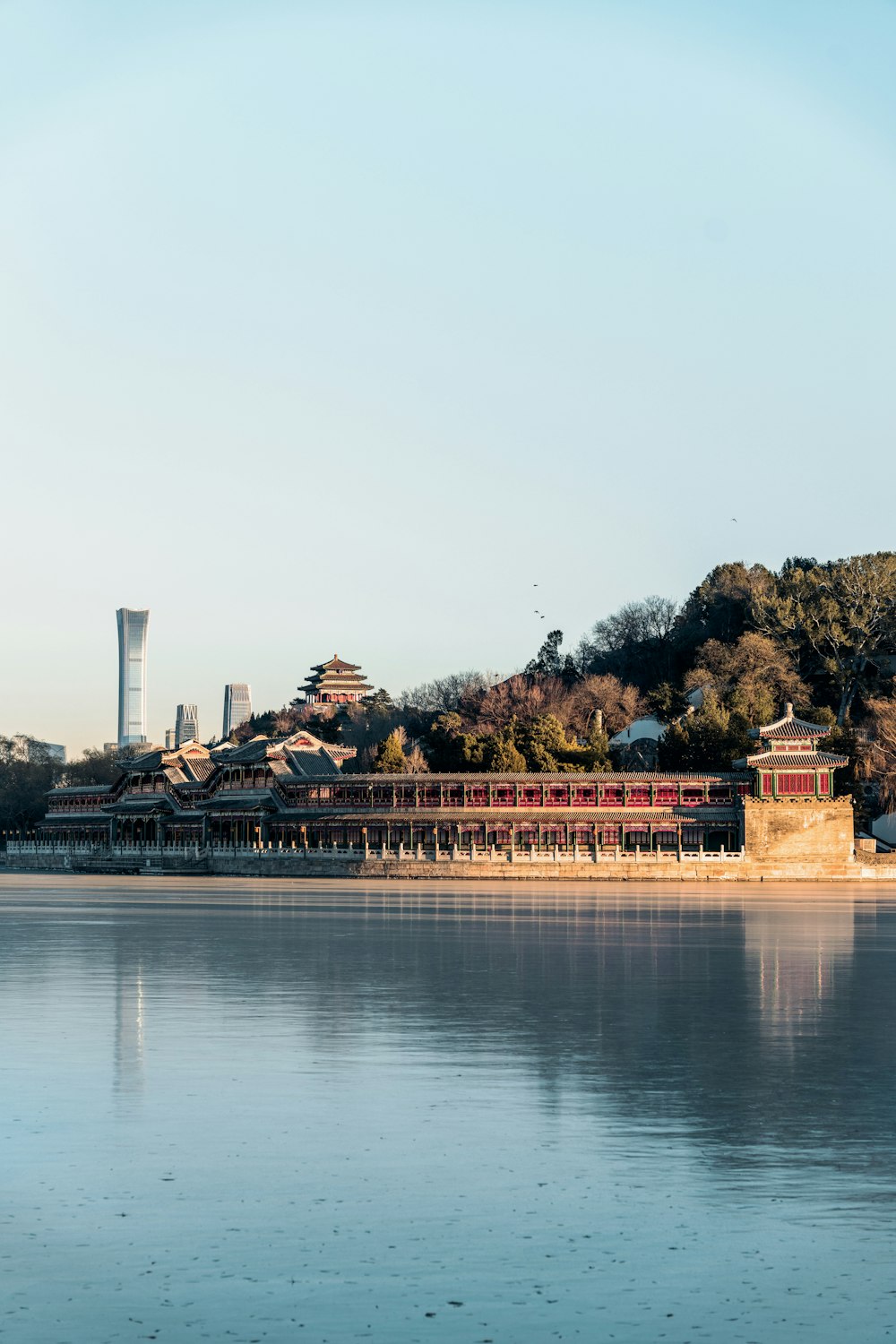 a large body of water with a building in the background