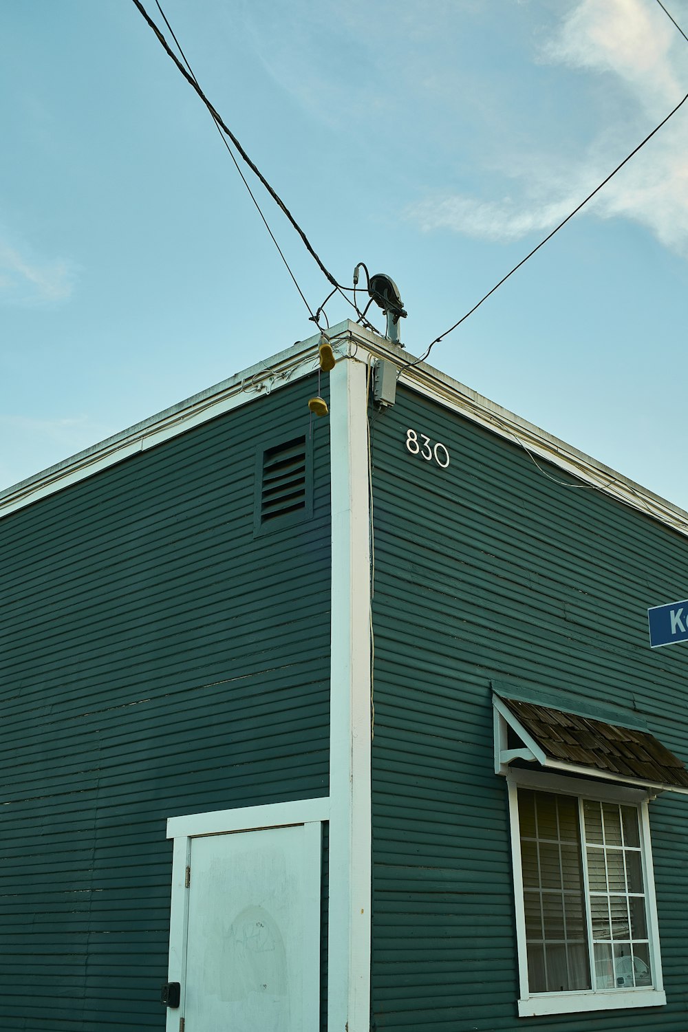 a blue building with a street sign on the side of it