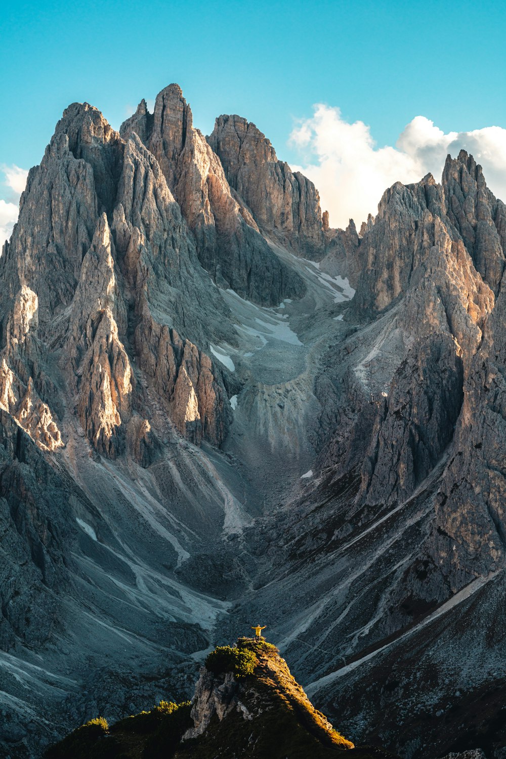 a mountain range covered in snow under a blue sky