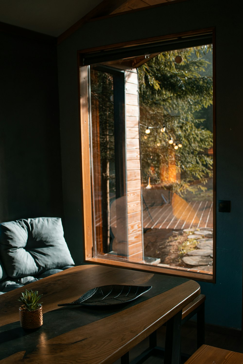 a wooden table sitting in front of a window