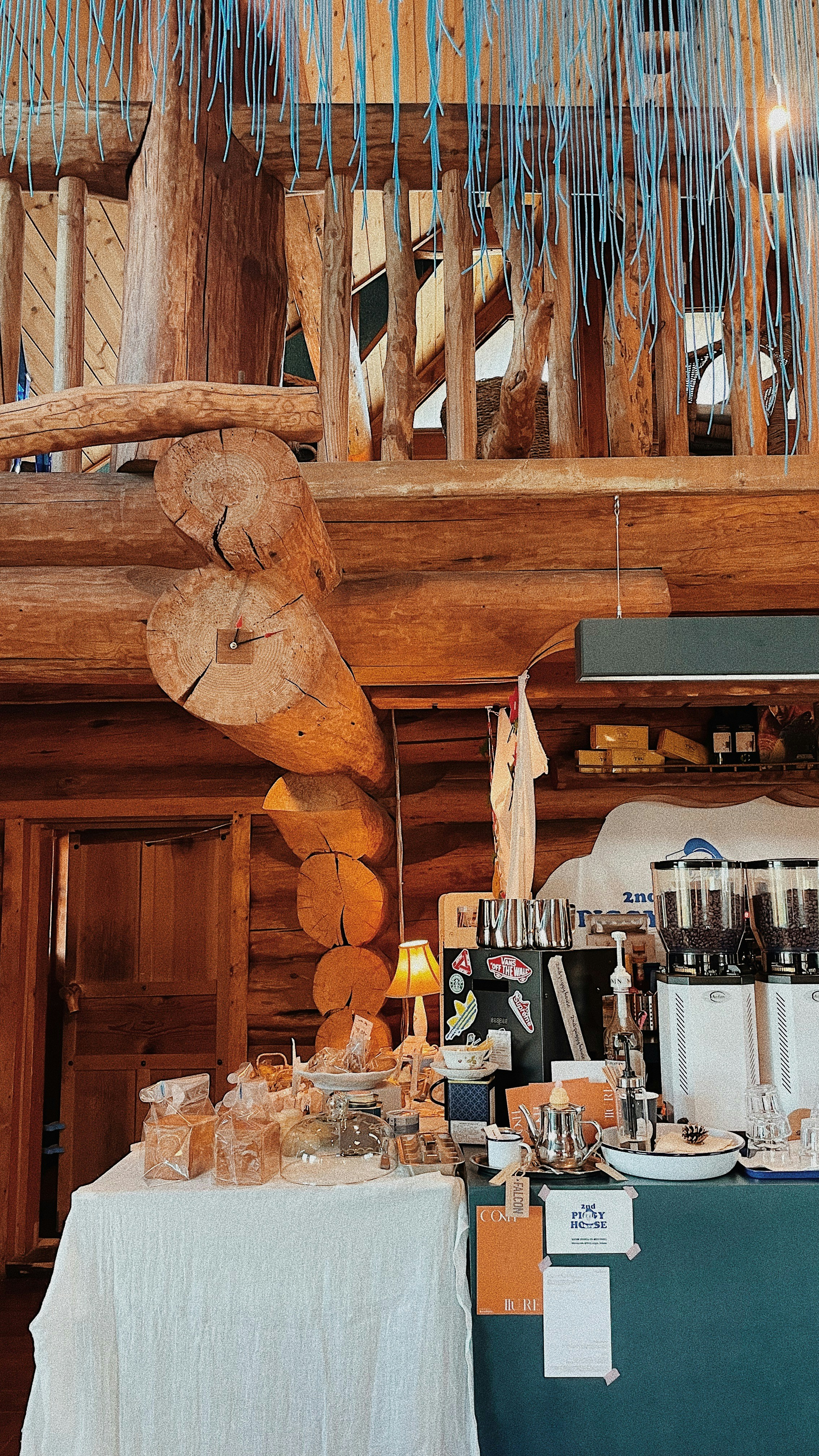 a wooden bear head hanging from the ceiling of a restaurant