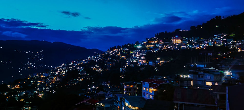 a night time view of a city on a hill