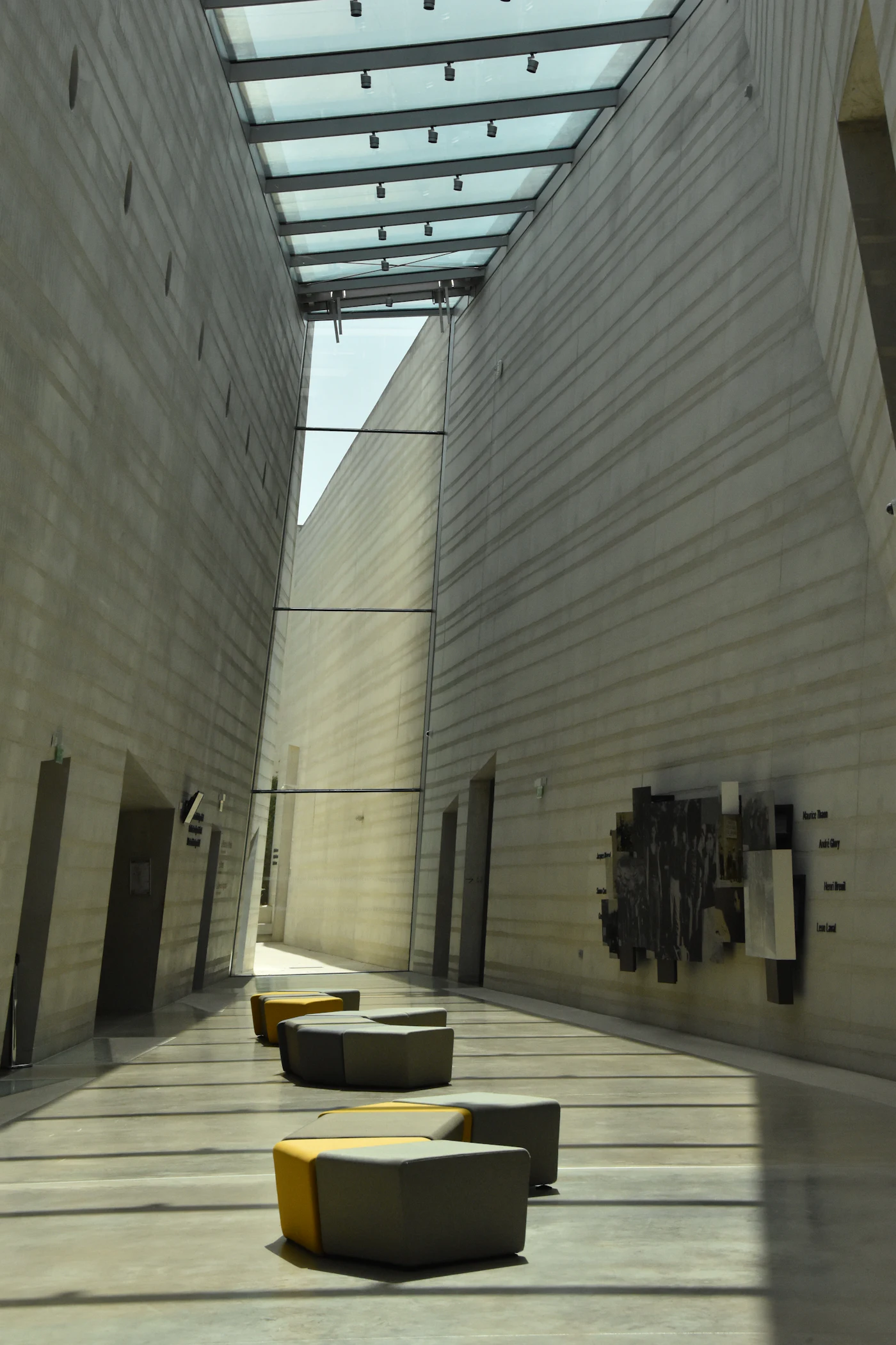 A long gallery hallway under a skylight