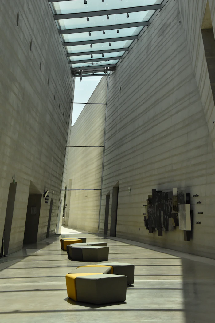 A long gallery hallway under a skylight
