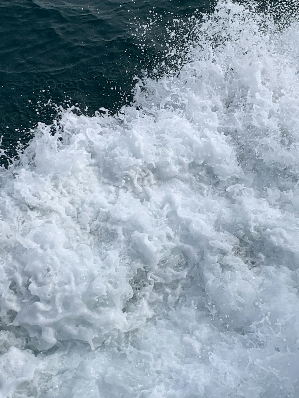 a person riding a surfboard on a wave in the ocean