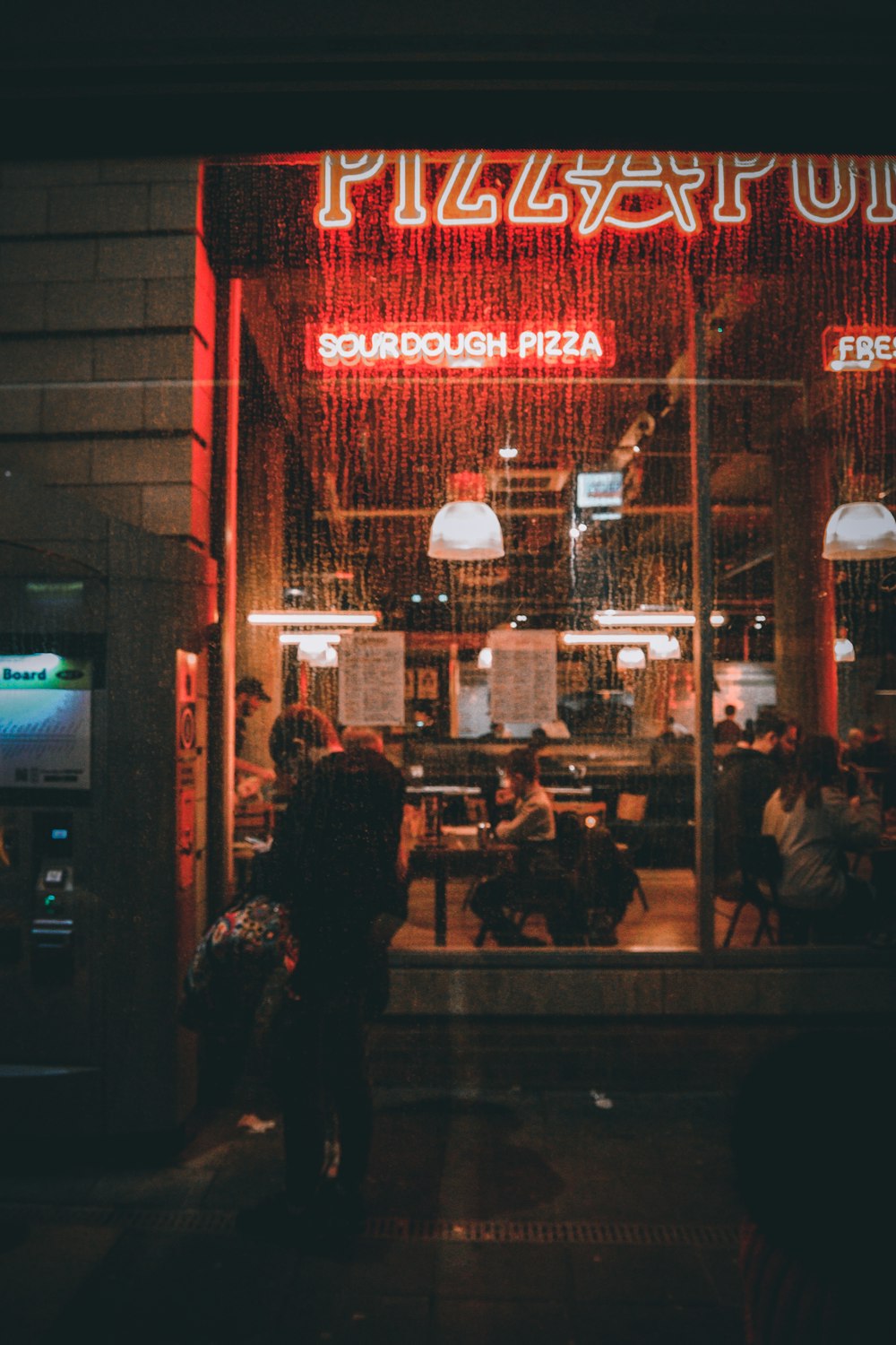 a group of people standing outside of a restaurant