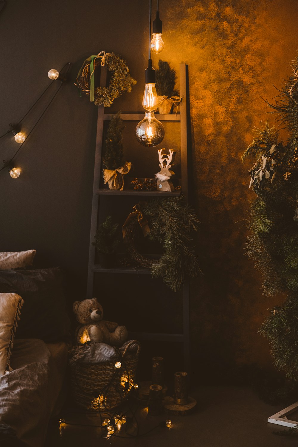 a shelf with christmas lights and a teddy bear