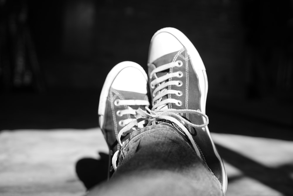 a black and white photo of a person's shoes