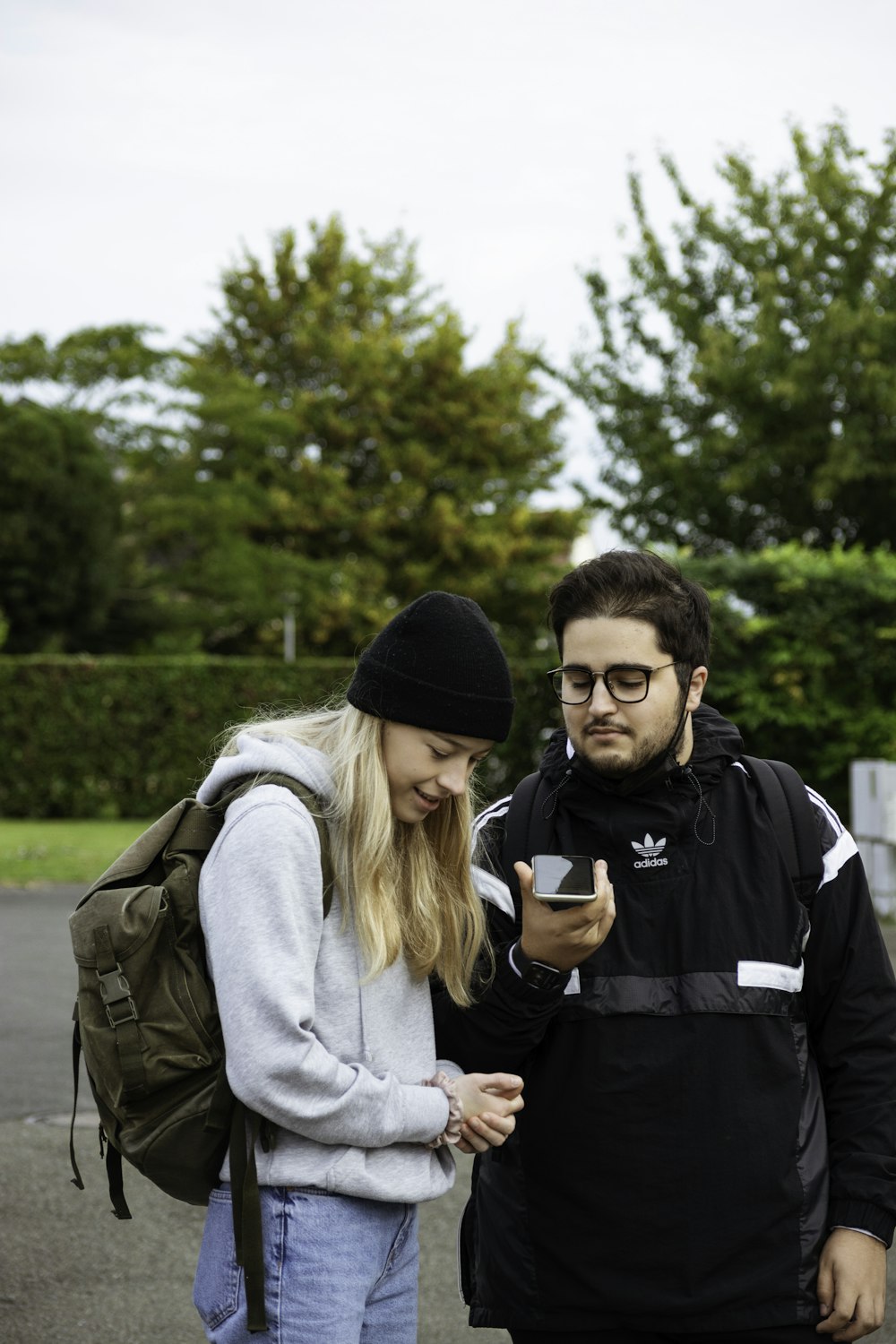 a man and a woman looking at a cell phone