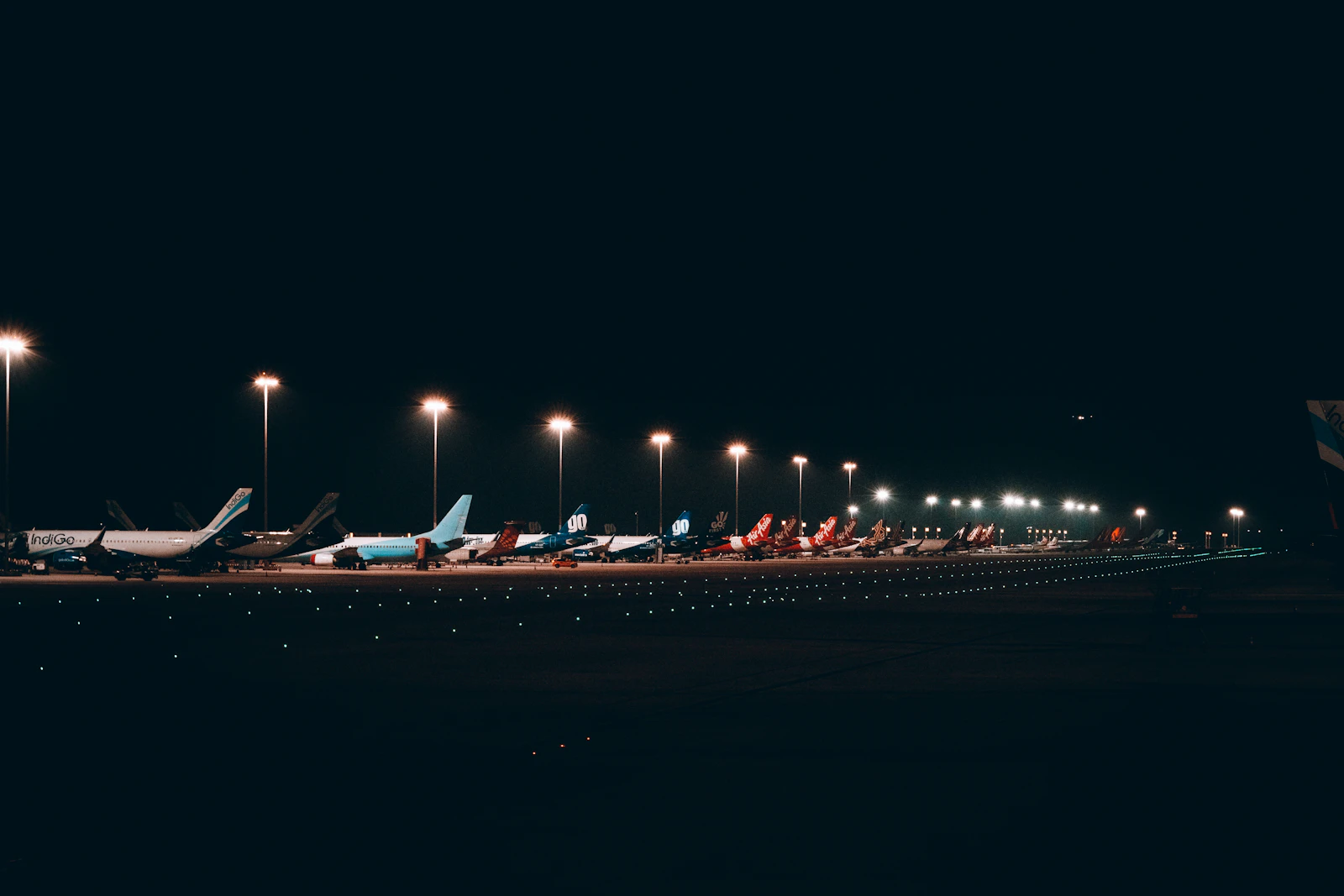 A row of airliners parked at an airport