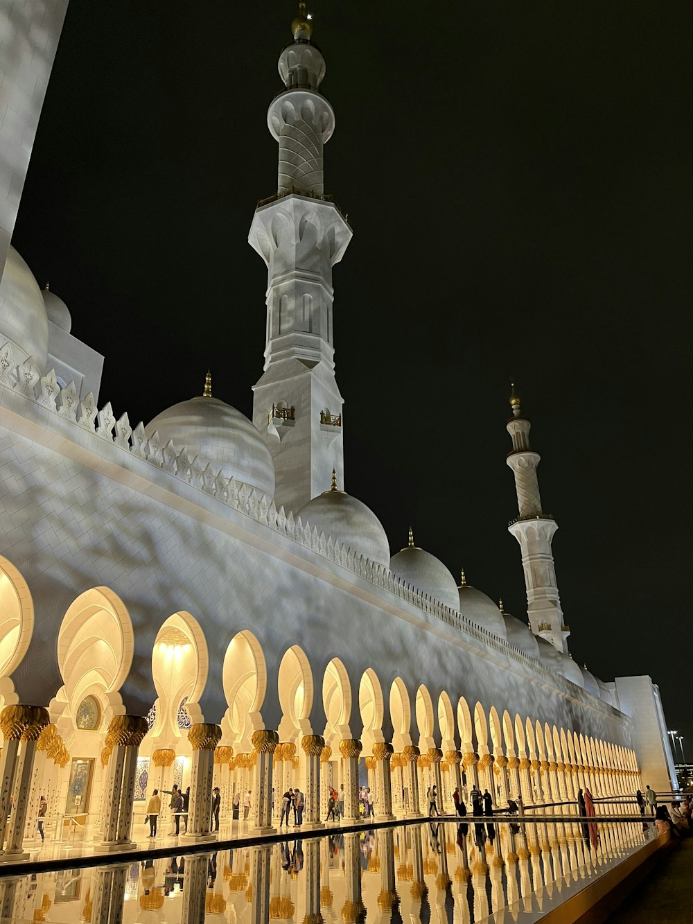 a large white building with a tall tower at night