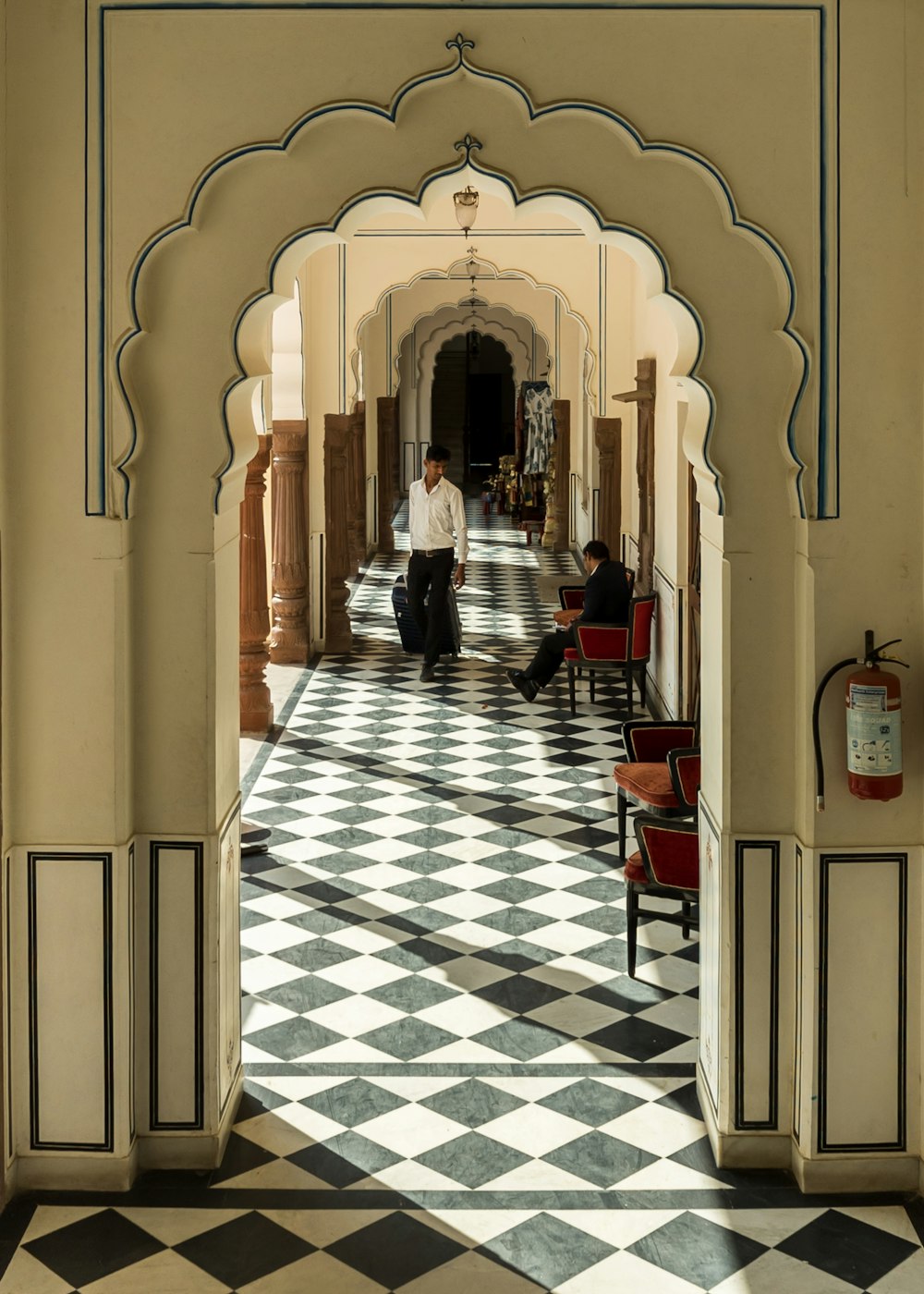 a man sitting on a chair in a hallway