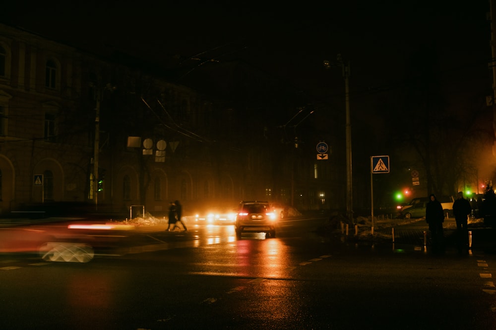 a car driving down a street at night