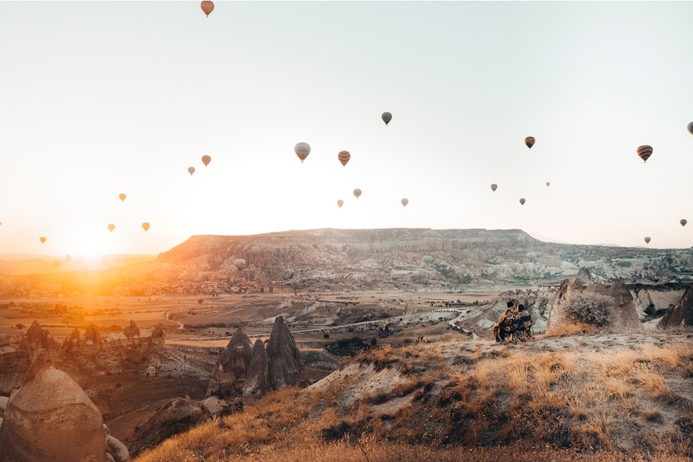 a group of hot air balloons flying in the sky