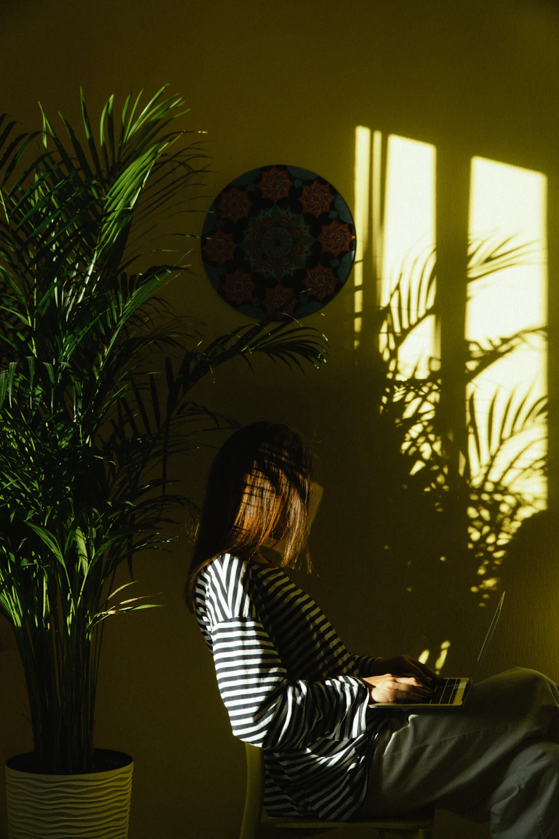 a woman sitting in a chair with a laptop