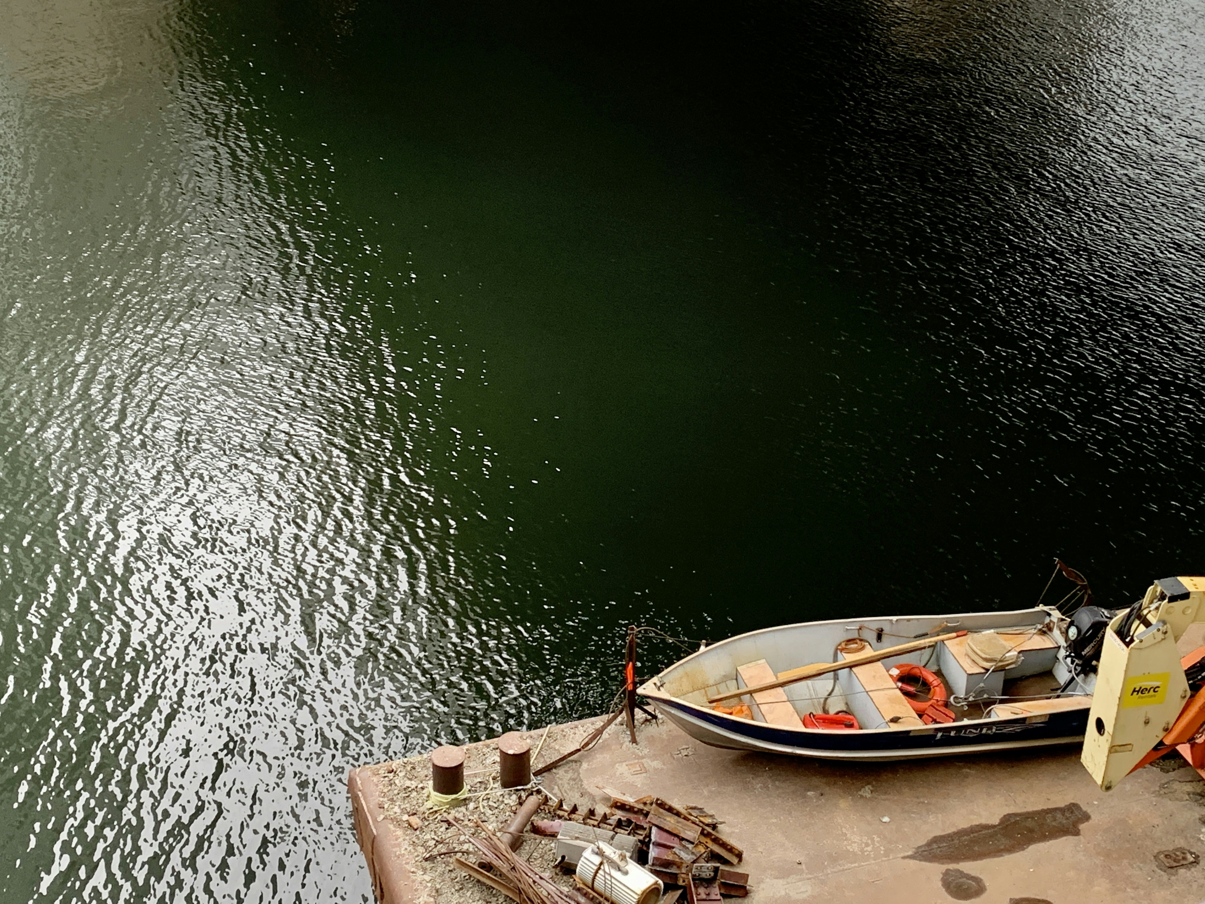 a small boat is docked at a dock