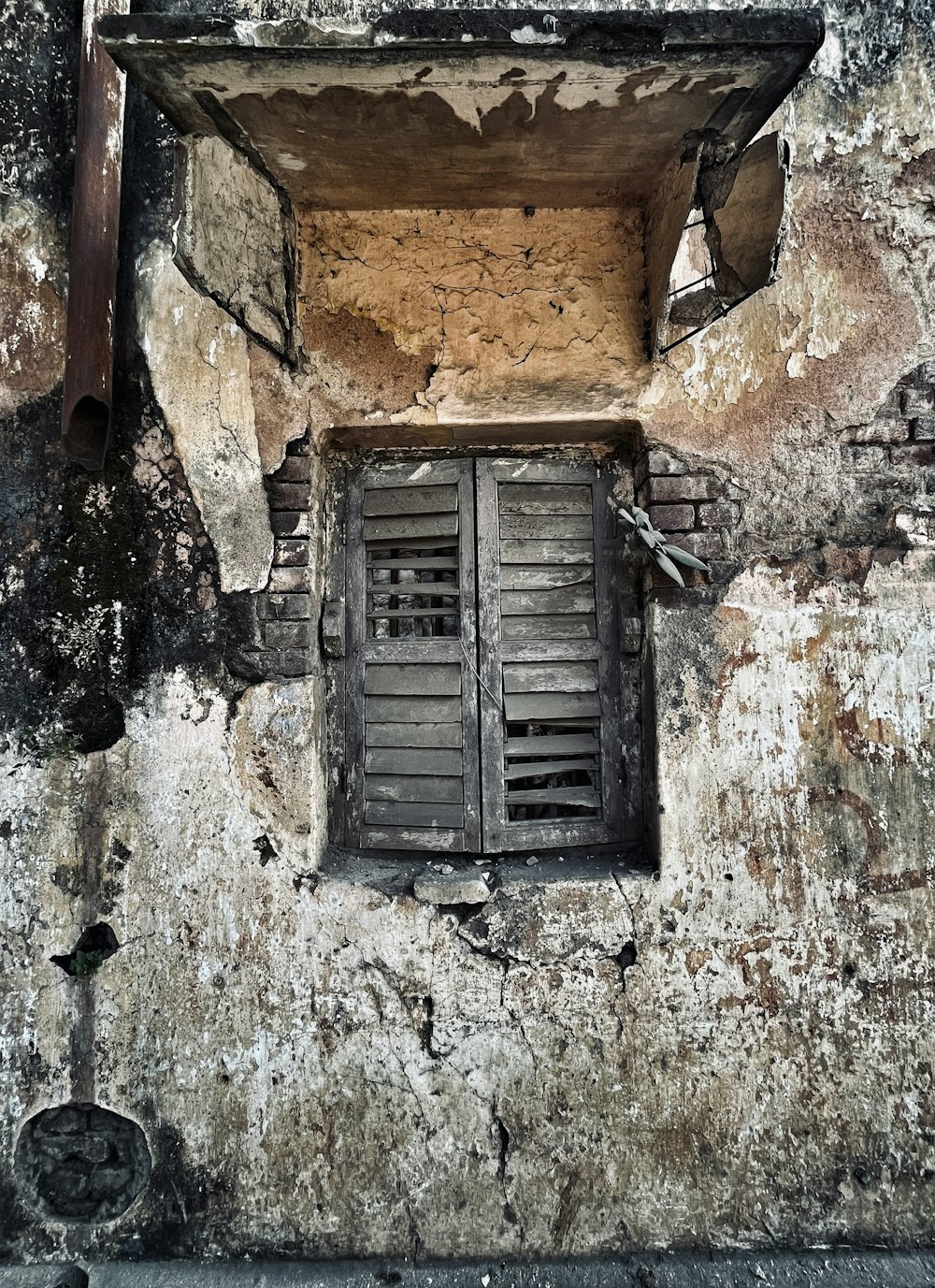 an old building with a window and shutters