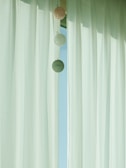 A stylish curtain rod holding warm-toned curtains in a minimalist setting.