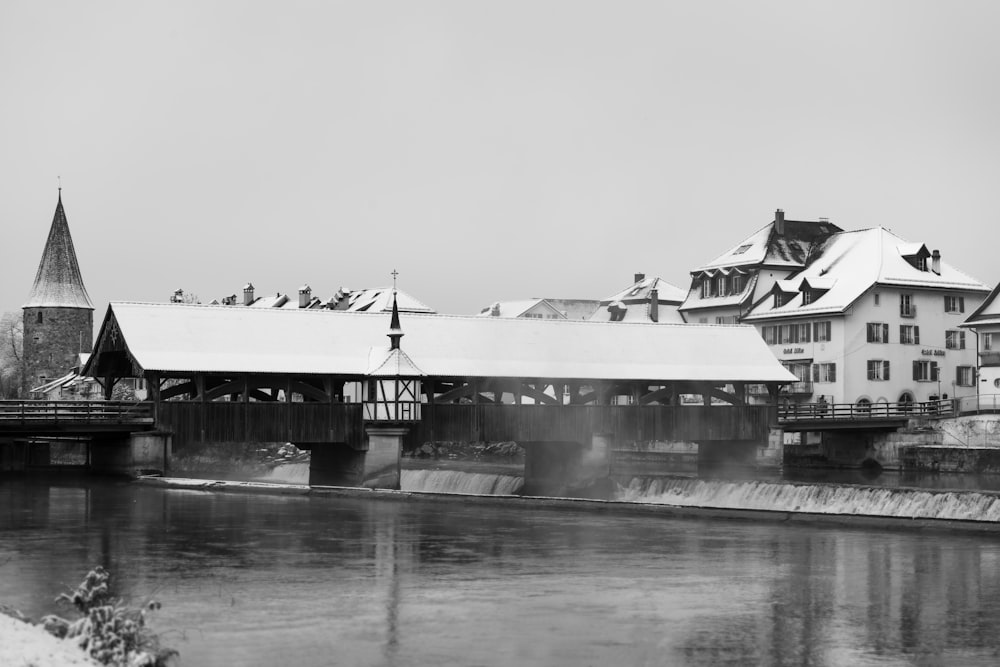 a black and white photo of a bridge over a river