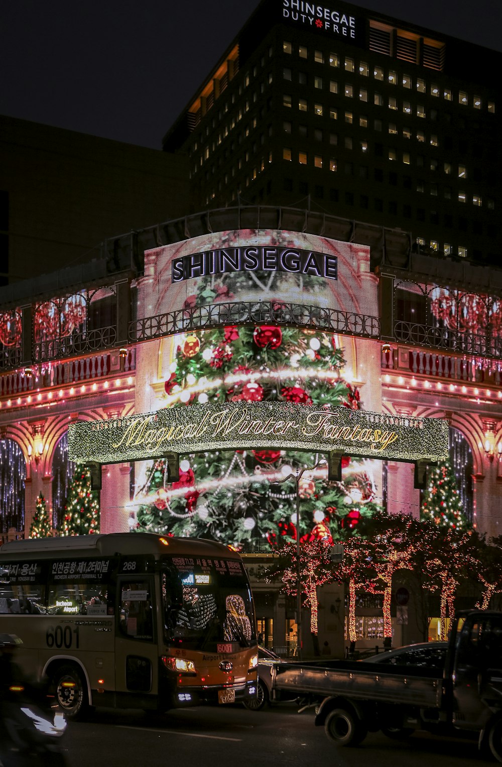 a large christmas tree is lit up on a building