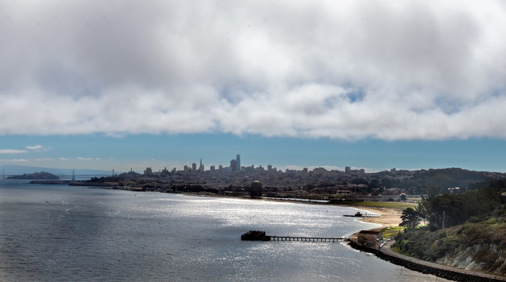 a body of water with a city in the background