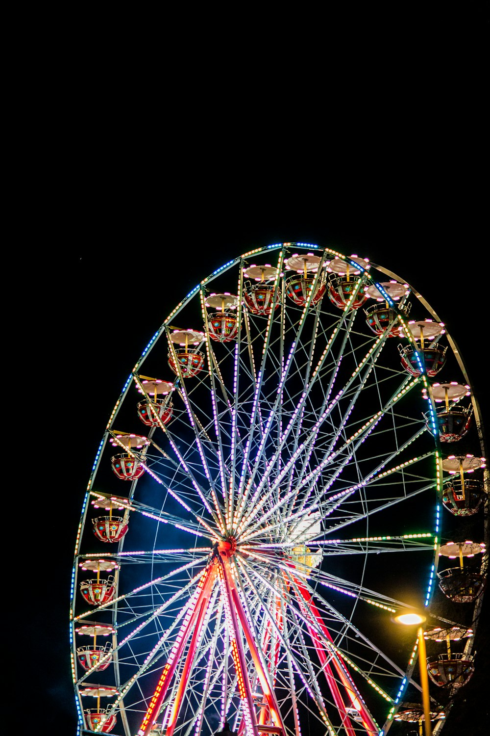 a ferris wheel is lit up at night