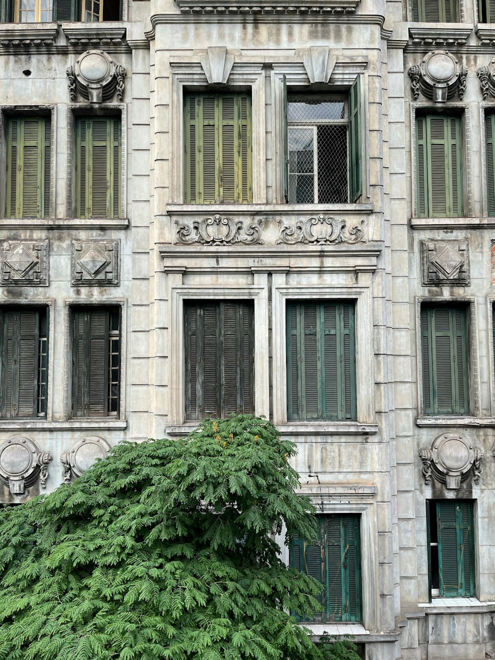 an old building with a tree in front of it