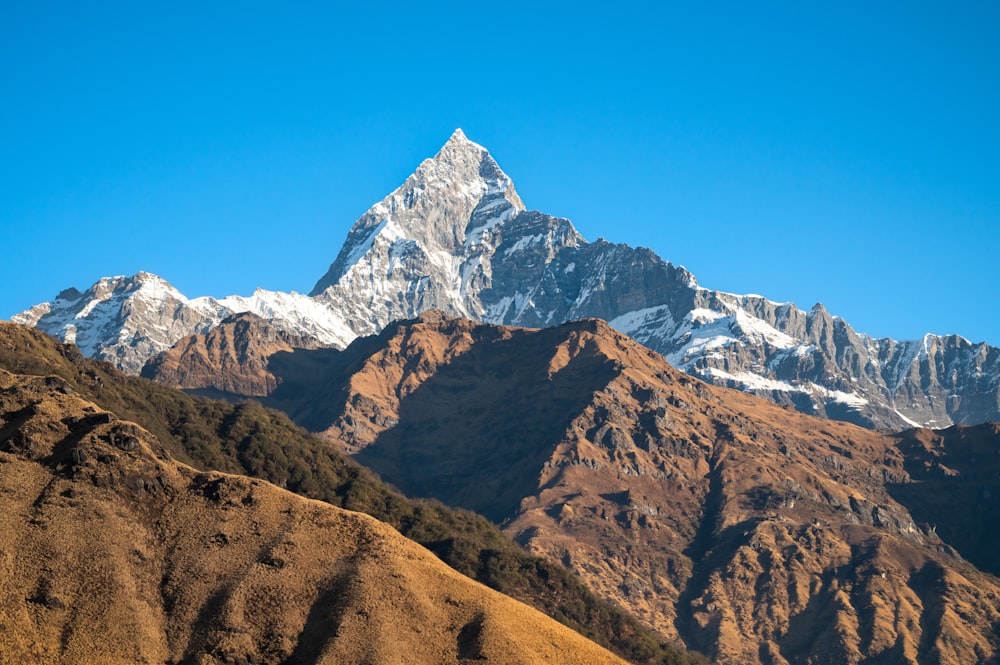 a view of a mountain range with snow on the top