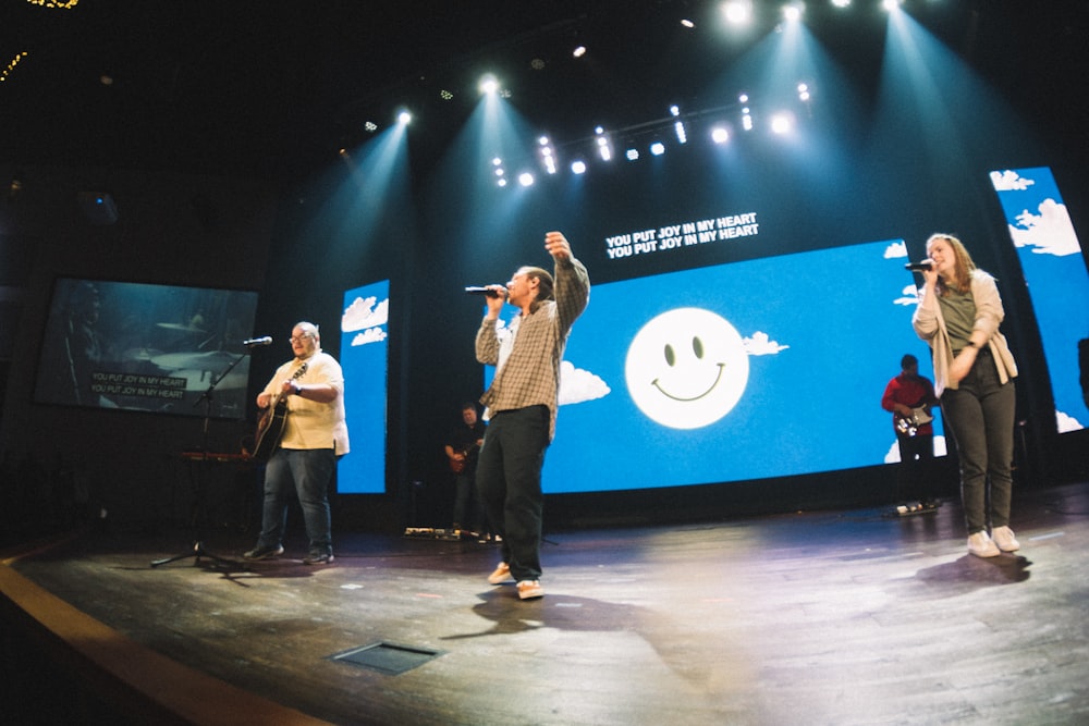 a group of people standing on top of a stage