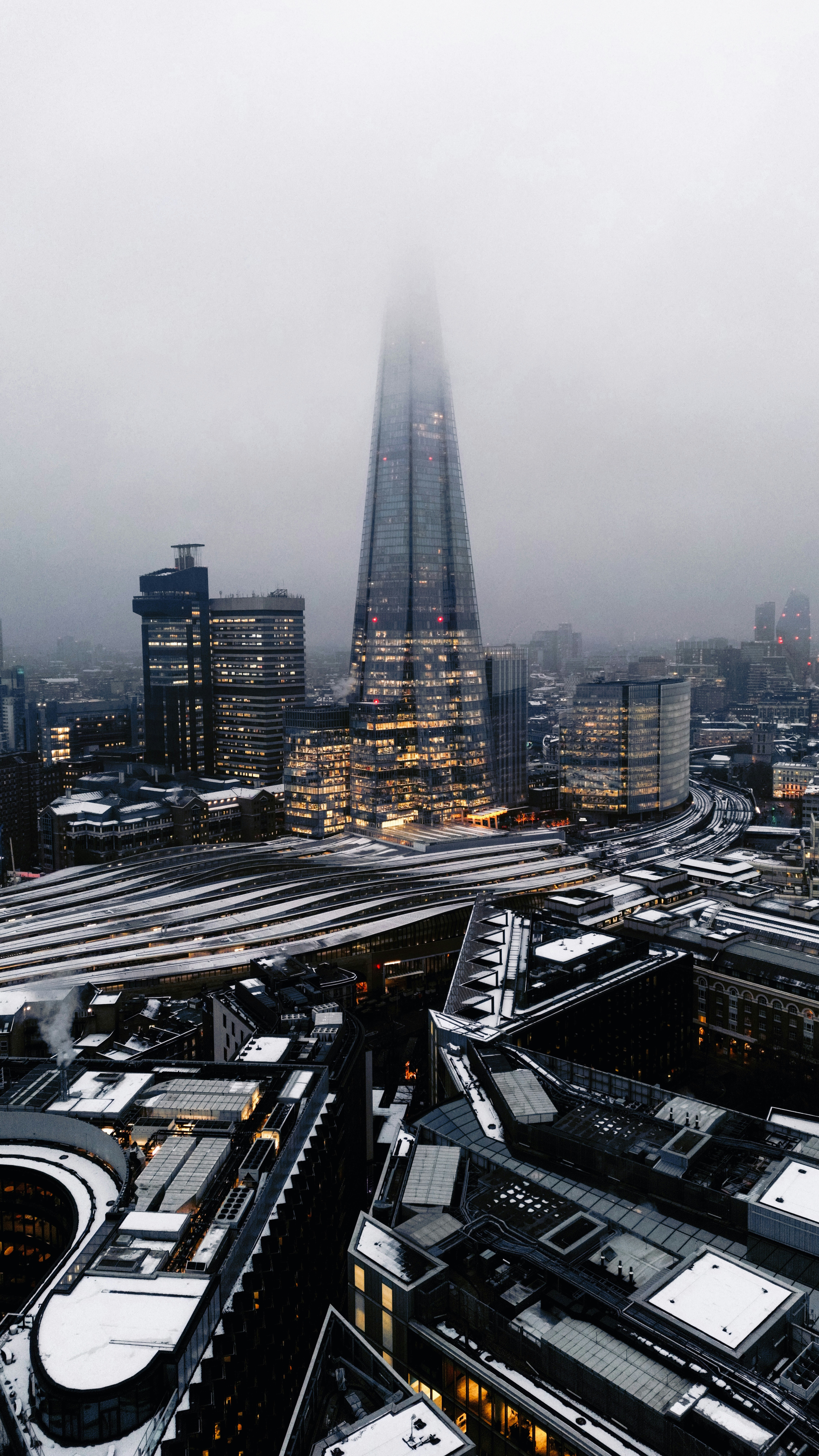 A very tall building towering over a city photo – Free Urban Image on ...