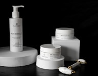 Sleek, clinical skincare containers arranged to highlight the Age protocol.