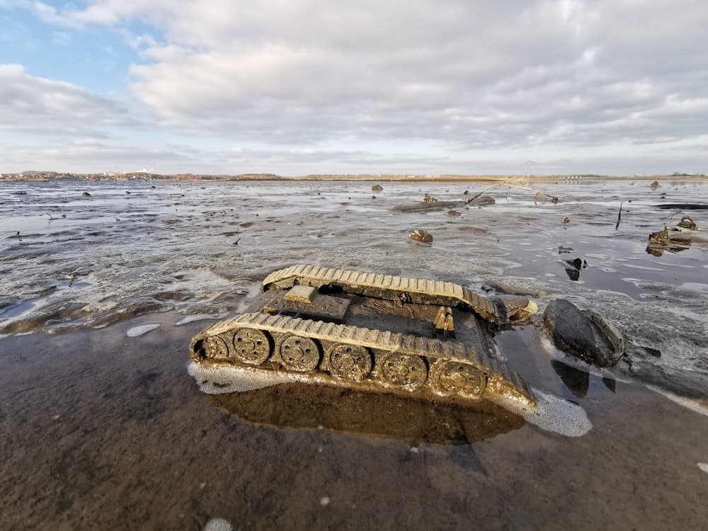 a tank sitting in the middle of a body of water