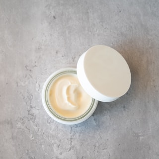 An open foundation compact with a smooth, creamy texture visible inside.