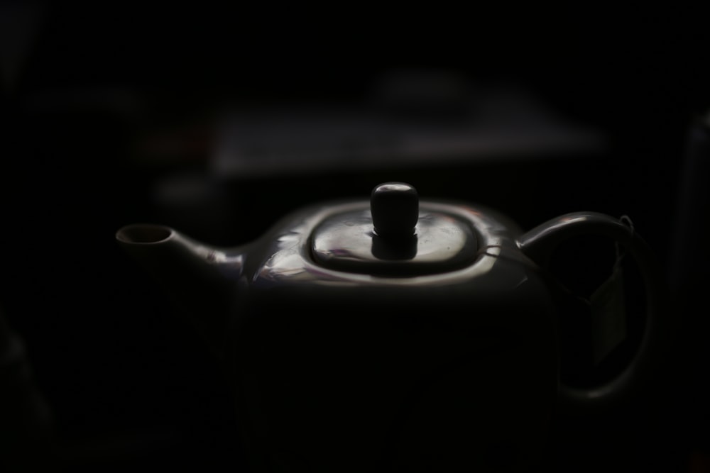 a black tea pot with a tea kettle on top of it