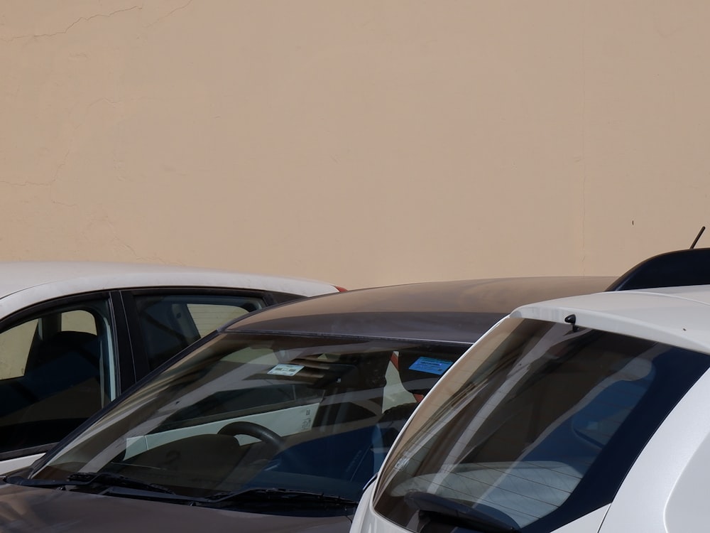 a couple of white cars parked next to each other